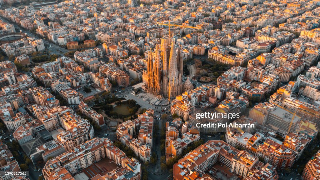 Aerial view of Barcelona and Sagrada Familia Cathedral at sunrise. Eixample residential famous urban grid. Catalonia, Spain