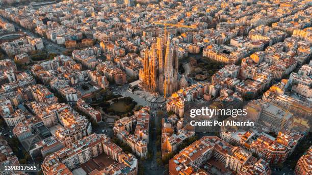 aerial view of barcelona and sagrada familia cathedral at sunrise. eixample residential famous urban grid. catalonia, spain - sagrada familia barcelona stock pictures, royalty-free photos & images
