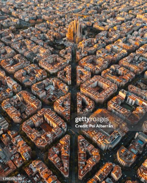 aerial view of barcelona eixample residential district and famous basilica sagrada familia at sunrise. catalonia, spain - barcelona aerial stock-fotos und bilder