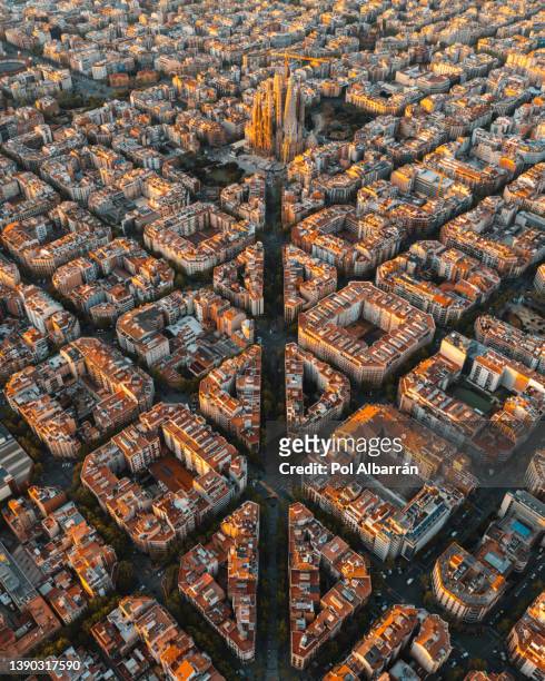 aerial view of barcelona eixample residential district and famous basilica sagrada familia at sunrise. catalonia, spain - calle barcelona fotografías e imágenes de stock