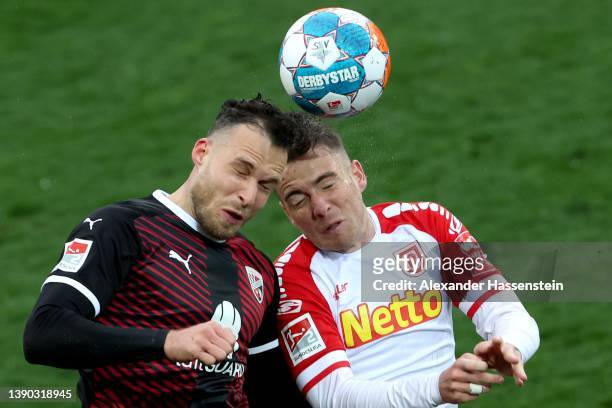 Max Besuschkow of Regensburg battles for the ball with Patrick Schmidt of Ingolstadt during the Second Bundesliga match between SSV Jahn Regensburg...