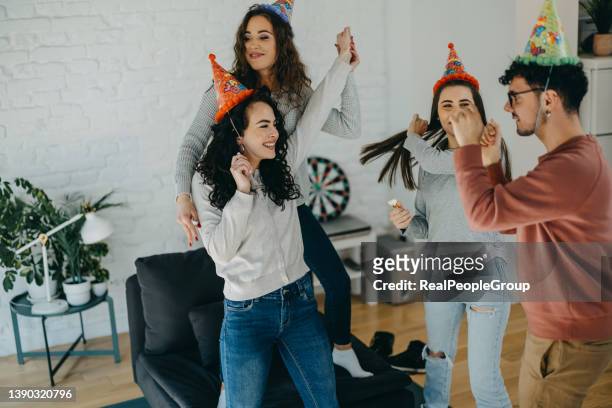 young adults celebrating a birthday party - college dorm party stock pictures, royalty-free photos & images