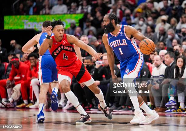 James Harden of the Philadelphia 76ers dribbles against Scottie Barnes of the Toronto Raptors during the second half of their basketball game at the...