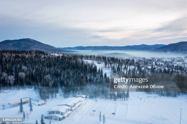 winter landscape in sheregesh ski resort in russia, located in mountain shoriya, siberia. frosty morning in siberia. morning fog over the forest - sibirien bildbanksfoton och bilder