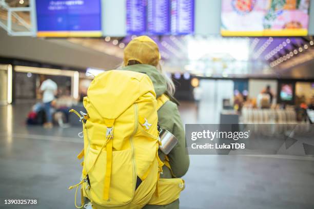 eine ungeduldige frau wartet am flughafen auf ein flugzeug. isl - bergsteiger mit karte und rucksack stock-fotos und bilder