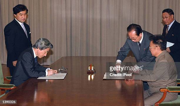 Japanese Prime Minister Junichiro Koizumi and North Korean leader Kim Jong-il sign a joint declaration at the Paekhwawon state guesthouse September...