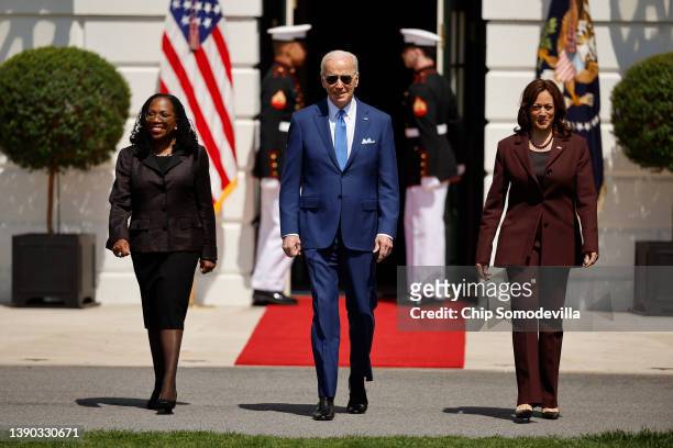 Judge Ketanji Brown Jackson, U.S. President Joe Biden and Vice President Kamala Harris walk out of the White House for an event celebrating Jackson's...