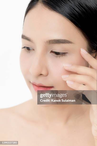 gorgeous woman posing on camera against white background - beauty cosmetic luxury studio background stock-fotos und bilder