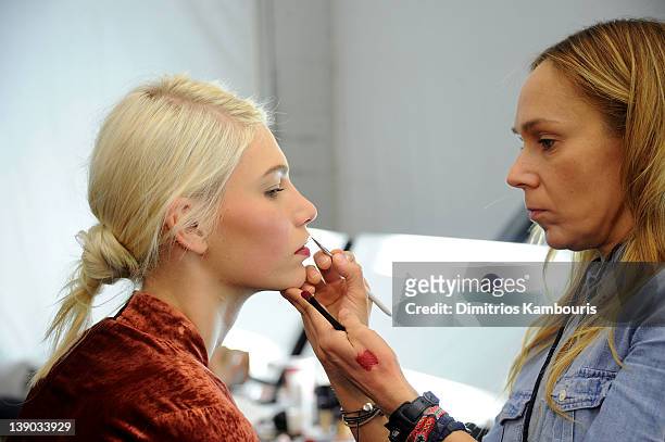 Model prepares backstage at the Michael Kors Fall 2012 fashion show during Mercedes-Benz Fashion Week at The Theatre at Lincoln Center on February...