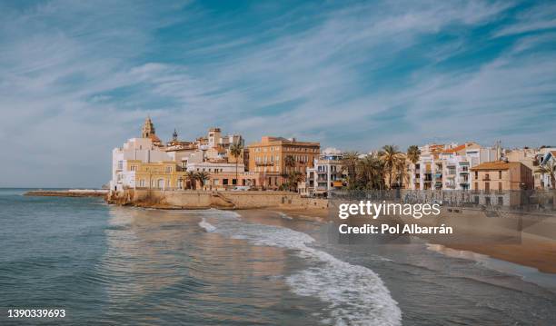 sand beach and historical old town in mediterranean resort sitges near barcelona, costa dorada, catalonia, spain - beaches near barcelona stock pictures, royalty-free photos & images