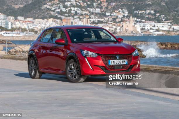 peugeot e-208 on a street - peugeot stock pictures, royalty-free photos & images