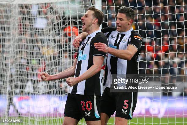 Chris Wood of Newcastle United celebrates with Fabian Scha after scoring the opening goal from the penalty spot during the Premier League match...