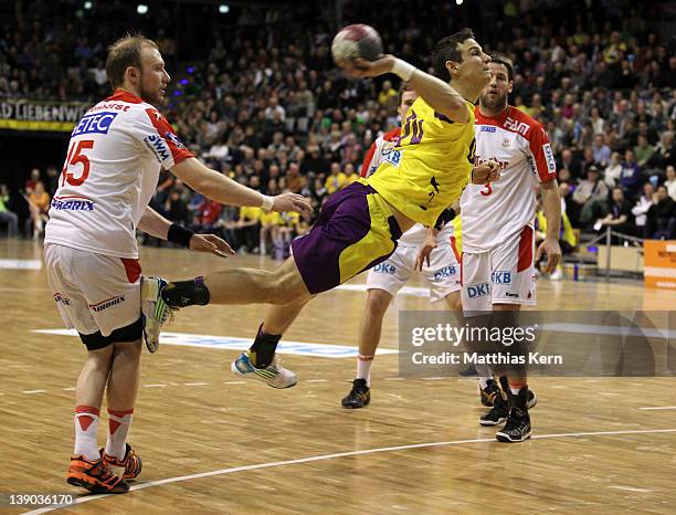 Bartlomiej Jaszka of Berlin is attacked by Yves Grafenhorst of Magdeburg during the Toyota Handball Bundesliga match between Fuechse Berlin and SC...