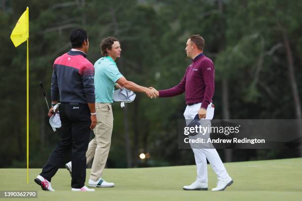 Hideki Matsuyama of Japan, amateur James Piot, and Justin Thomas shake hands on the 18th green after finishing their round during the second round of...