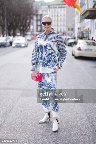 Best ager model and influencer Petra van Bremen wearing a blue and white blouse and matching pants with stripes, animal and floral print by...