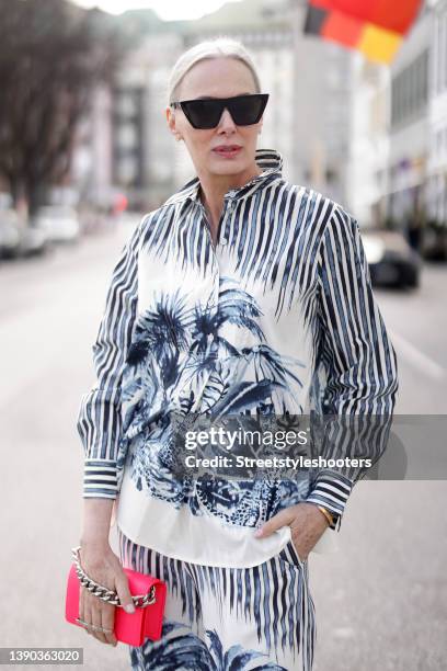 Best ager model and influencer Petra van Bremen wearing a blue and white blouse and matching pants with stripes, animal and floral print by Margittes...