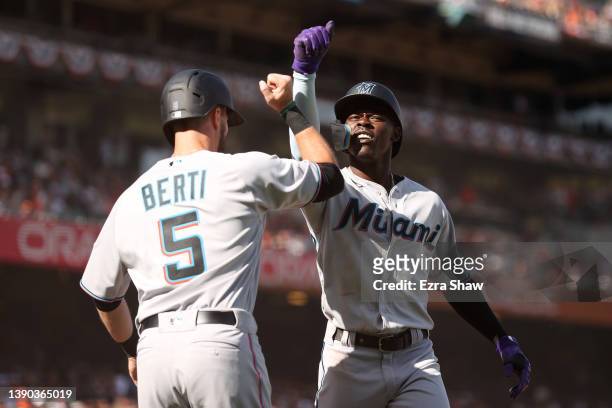 Jazz Chisholm Jr. #2 of the Miami Marlins is congratulated by Jon Berti after he hit a two run home run in the ninth inning against the San Francisco...