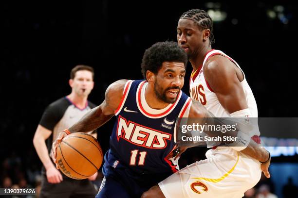 Kyrie Irving of the Brooklyn Nets dribbles as Caris LeVert of the Cleveland Cavaliers defends during the first half at Barclays Center on April 08,...