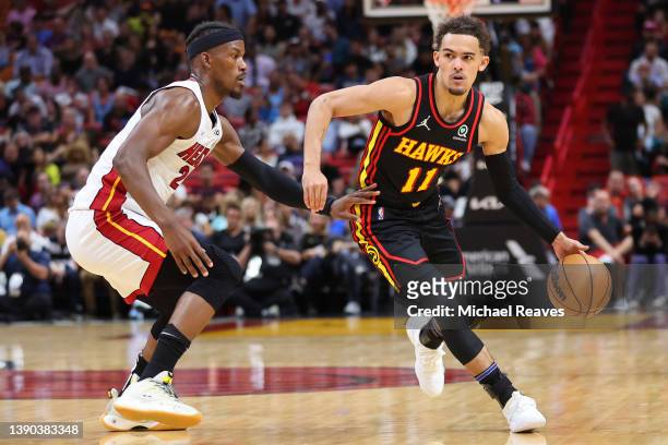 Trae Young of the Atlanta Hawks dribbles against Jimmy Butler of the Miami Heat during the first half at FTX Arena on April 08, 2022 in Miami,...