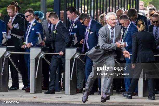 People race through the turnstiles as they open ahead of of The Championships Day 2, Longines Queen Elizabeth Stakes Day at Royal Randwick Racecourse...