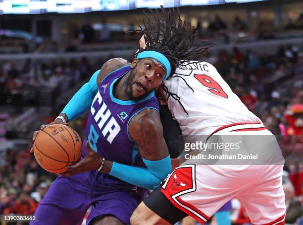 Montrezl Harrell of the Charlotte Hornets drives around Nikola Vucevic of the Chicago Bulls at the United Center on April 08, 2022 in Chicago,...