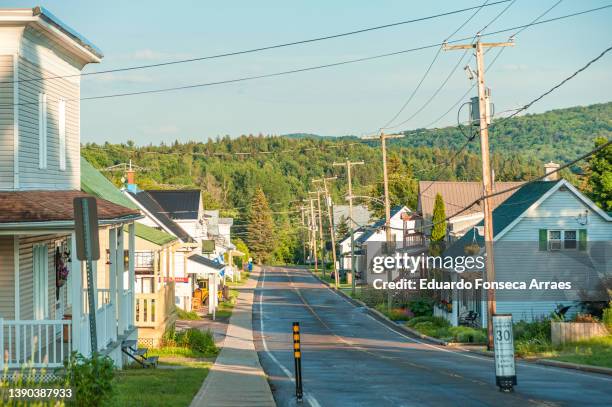 view of the main street of the small town of saint-damien in the lanaudière region - house golden hour stock pictures, royalty-free photos & images