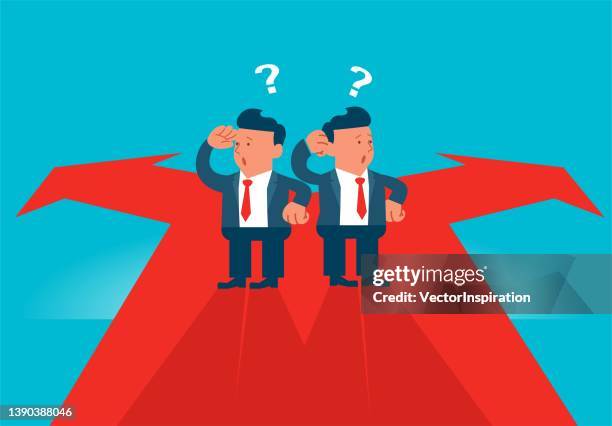 two cartoon businessmen standing in the middle of a fork in left and right road signs. - crossroads sign stock illustrations