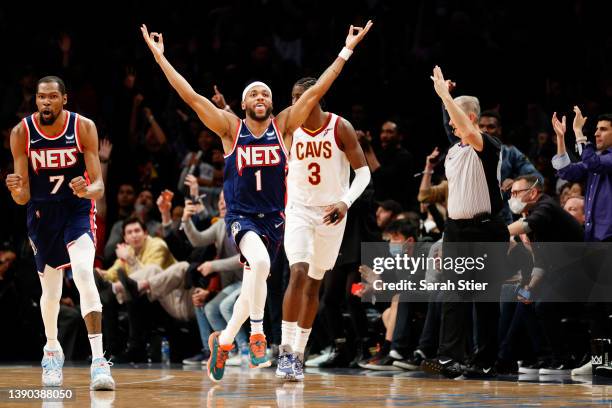 Bruce Brown of the Brooklyn Nets reacts with Kevin Durant after making a three-point basket during the second half against the Cleveland Cavaliers at...