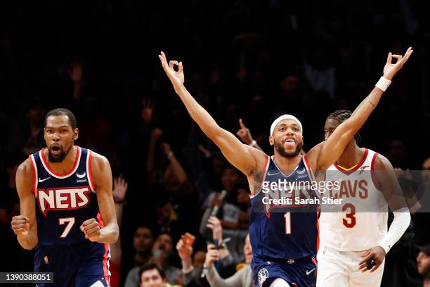 Bruce Brown of the Brooklyn Nets reacts with Kevin Durant after making a three-point basket during the second half against the Cleveland Cavaliers at...