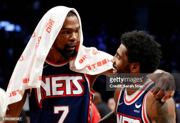 Kevin Durant reacts with Kyrie Irving of the Brooklyn Nets after the second half against the Cleveland Cavaliers at Barclays Center on April 08, 2022...