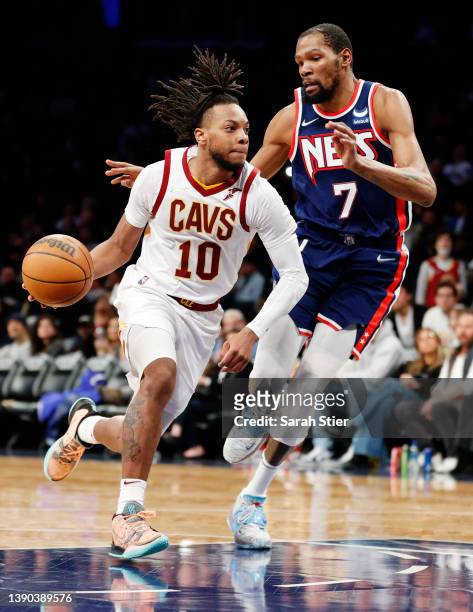 Darius Garland of the Cleveland Cavaliers dribbles as Kevin Durant of the Brooklyn Nets defends during the second half at Barclays Center on April...