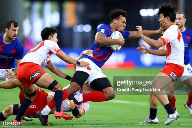 Jordan Sepho of France runs with the ball against Kazuma Nakagawa, Moeki Fukushi and Hibiki Yamada of Japan in their pool match during the HSBC...