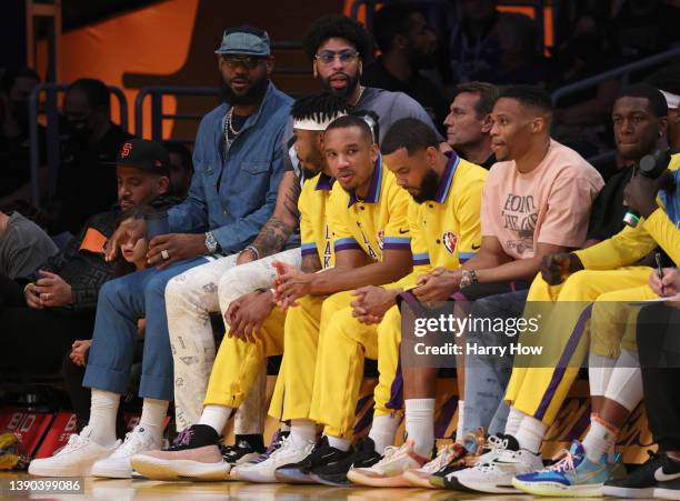 LeBron James and Anthony Davis of the Los Angeles Lakers watch play from the bench during the first half against the Oklahoma City Thunder at...