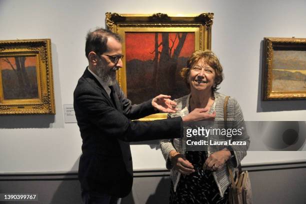 Curator Sergio Rebora jokes with the Curator Aurora Scotti while posing for a photograph during the opening of the exhibition 'Vittore Grubicy De...