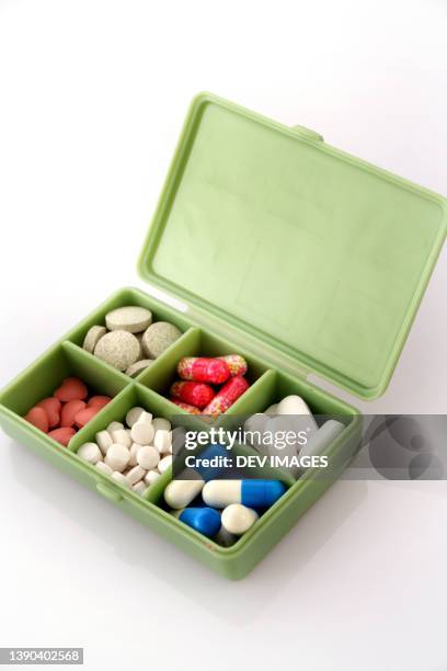 close up of pill box against white background - woche stock-fotos und bilder