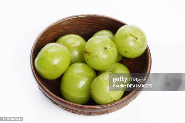 fresh gooseberries in wooden bowl - gooseberries stock pictures, royalty-free photos & images