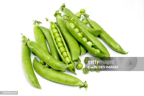 green peas on white background - green pea stock pictures, royalty-free photos & images