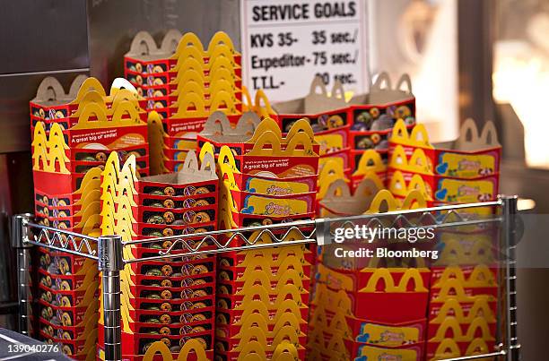 Happy Meal boxes sit stacked next to the drive-thru window of a McDonald's Corp. Restaurant in Little Falls, New Jersey, U.S., on Wednesday, Feb. 15,...