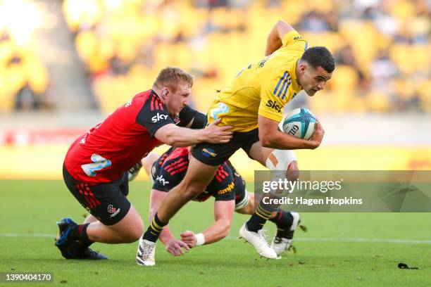 Josh Moorby of the Hurricanes is tackled by Fletcher Newell of the Crusaders during the round eight Super Rugby Pacific match between the Hurricanes...