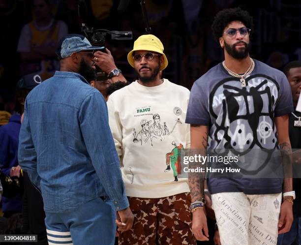 LeBron James, Carmelo Anthony and Anthony Davis of the Los Angeles Lakers courtside after a 120-101 Lakers win over the Oklahoma City Thunder at...