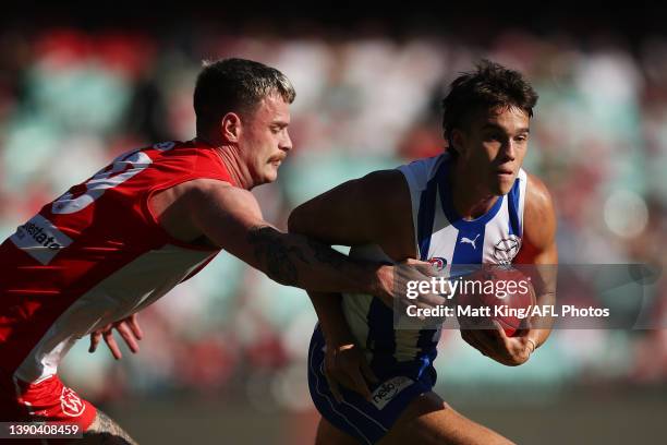 Flynn Perez of the Kangaroosis challenged by Peter Ladhams of the Swans during the round four AFL match between the Sydney Swans and the North...