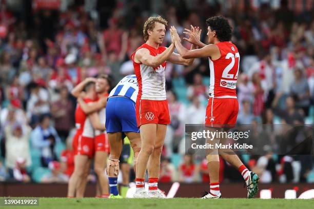 Callum Mills and Justin McInerney of the Swans celebrate victory during the round four AFL match between the Sydney Swans and the North Melbourne...