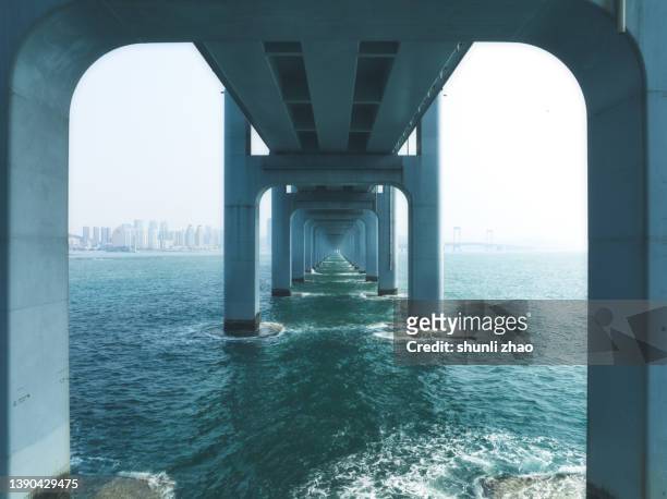 below the bridge - architecture symmetry stock-fotos und bilder