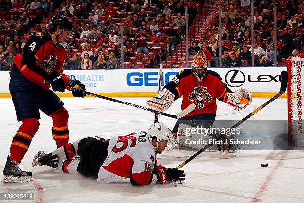 Goaltender Scott Clemmensen of the Florida Panthers defends the net with the help of teammate Keaton Ellerby against Bobby Butler of the Ottawa...