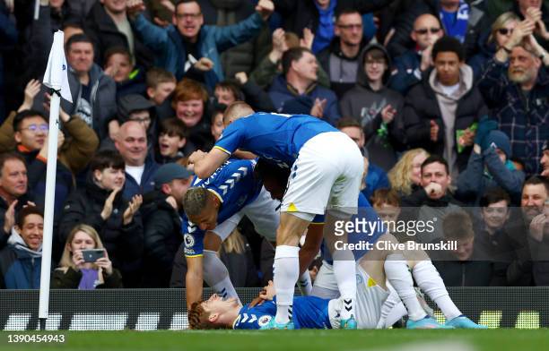 Anthony Gordon of Everton celebrates with teammates after scoring their team's first goal during the Premier League match between Everton and...