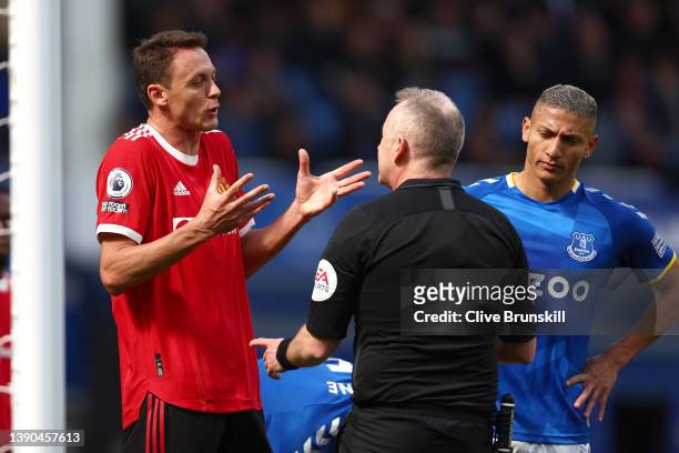 Nemanja Matic of Manchester United and Richarlison of Everton speak to referee Jonathan Moss during the Premier League match between Everton and...