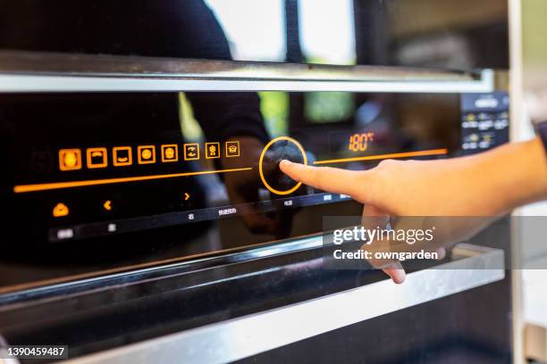 the woman baking cookies in her kitchen - cooker dial stock pictures, royalty-free photos & images