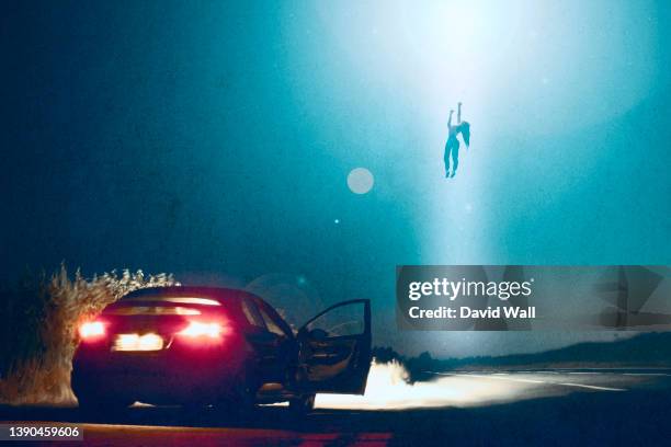 an alien encounter of a woman being abducted and floating in the sky by a ufo, next to her car at night - ontvoering stockfoto's en -beelden