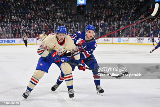 Olivier Galipeau of the Laval Rocket and John Peterka of the Rochester Americans skate against each other during the third period at Place Bell on...