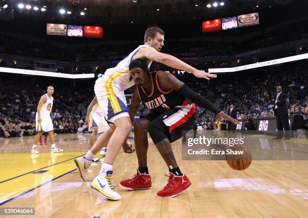 Gerald Wallace of the Portland Trail Blazers drives on David Lee of the Golden State Warriors at Oracle Arena on February 15, 2012 in Oakland,...